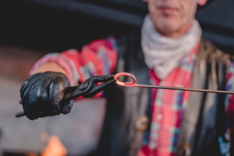 bokeh, adult, handmade, focus on foreground, 4K, casual clothing, hands, indoors, jewellery, men, one person, holding, finger ring, hammer, bear, front view