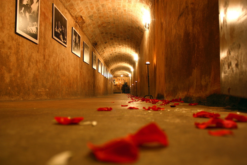 lighting equipment, feast, rosa, night, candle, architecture, formal wear, empty, wedding, underground, stones, rock, flowers, floor, cellar, red, environment