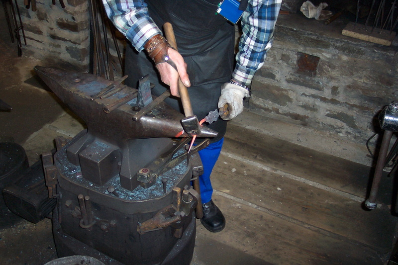 workshop, mechanic, holding, occupation, hand, forge, indoors, metal, human hand, midsection, craft, anvil, standing, embers, real people, men, hand tool