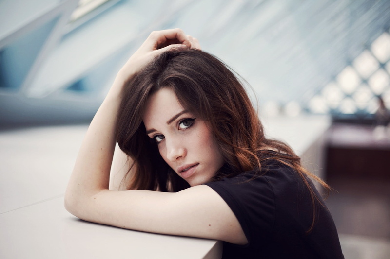 focus on foreground, top, casual clothing, auburn hair, depth of field, portrait, contemplation, long hair, woman, black, hairstyle, adult, beautiful woman