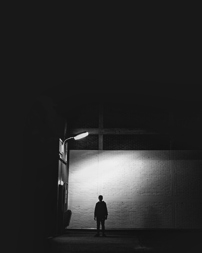 real people, waiting, copy space, lifestyles, rear view, lamp post, black-and-white, standing, lamp, architecture, men, 4K, illuminated, indoors, contemplation