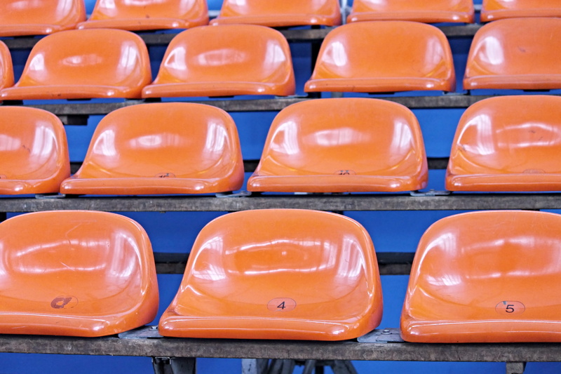 bank, bucket seats, watch, seating, large group of objects, repetition, empty, sit, indoors, ice rink, arrangement, rows of seats, viewers, no people, plastic