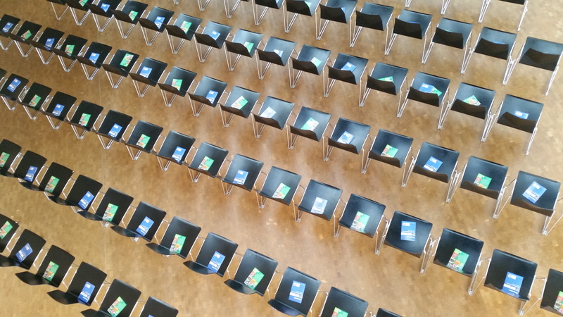 chairs, building, repetition, concert, seats, empty, furniture, outdoors, concert chairs, tilt, no people, stacking chairs, classical concert, low angle view