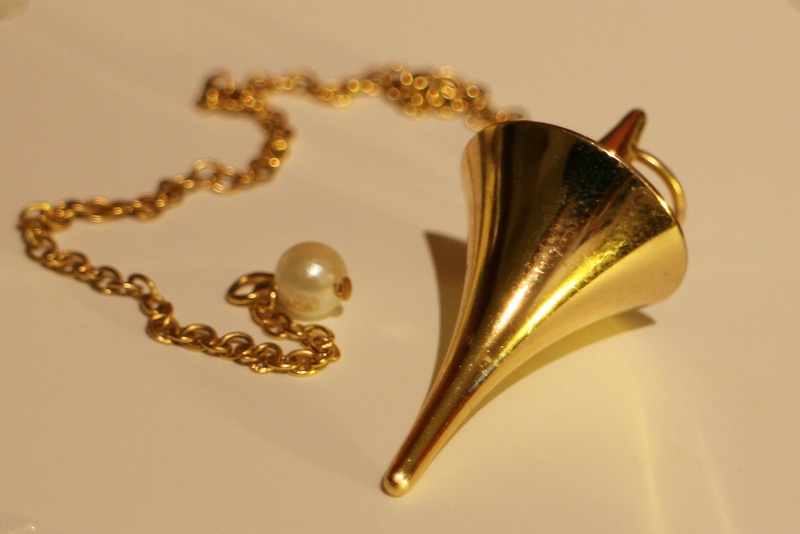 personal accessory, tool, metal, indoors, vibration frequency, wealth, cone, jewelry, surface, silver colored, shiny, frequency, no people, heart shape