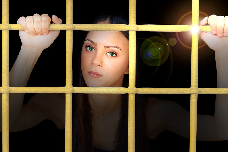 building, looking, holding, woman, architecture, punishment, prison, emotion, head, headshot, looking at camera, 2K, front view, young adult, prison bars