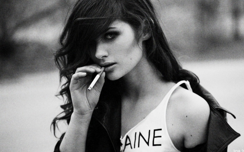 monochrome, hair in face, smoking issues, social issues, lifestyles, hairstyle, headshot, focus on foreground, communication, 2K, young women, cigarette