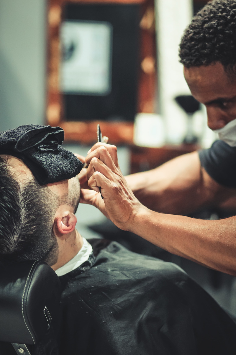 lifestyles, blurred background, young men, two people, looking, young adult, towel, shop, real people, men, hair, hand, man, fashion, human hand, hairdo