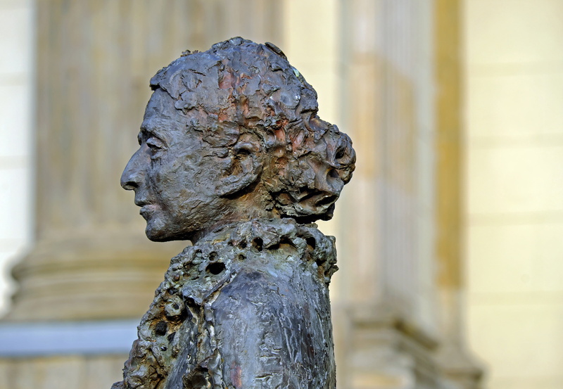 male likeness, focus on foreground, architecture, carving - craft product, statue, bronze sculpture, history, close-up, focus, built structure, photography