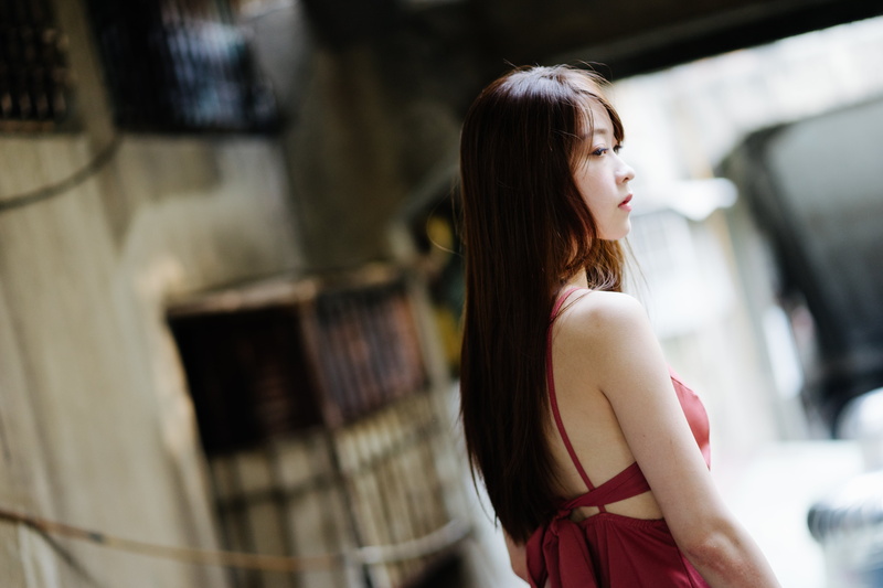 women, brown hair, dress, adult, day, outdoors, focus on foreground, fashion, Asian, hairstyle, beauty, standing, profile view, one person, looking, looking over shoulder