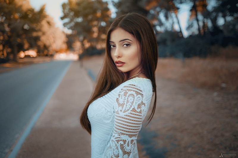 looking over shoulder, women outdoors, young adult, one person, standing, beauty, face, focus on foreground, brown hair, white clothing, leisure activity