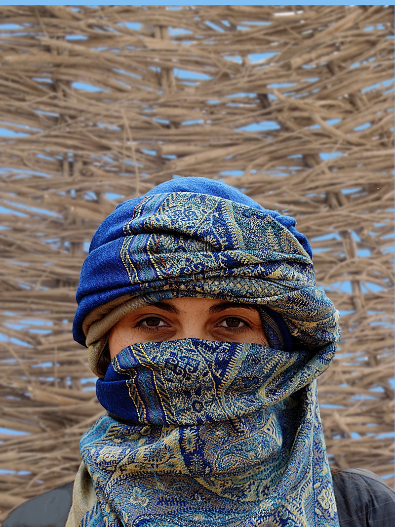 hat, one person, warm clothing, clothing, turban, hijab, body part, veil, knit hat, portrait, close-up, obscured face, adult, snow, real people, focus on foreground