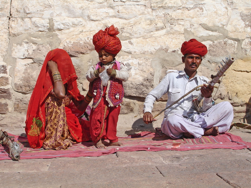 sitting, woman, real people, holding, red, relatives, parents, mother, kerchief, artist, street musicians, together, Family, musicians, traditional clothing