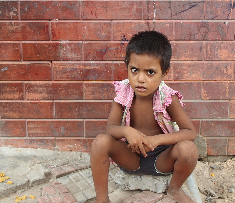 real people, asia, childhood, shorts, brick, front view, 2K, india, sitting, brick wall, day, new delhi, looking at camera, wall, architecture, depression - sadness