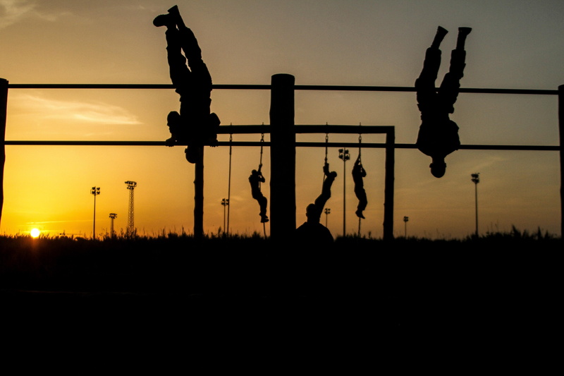 person, training, soldiers, near, human representation, statue, physical, outdoors, representation, twilight, dusk, street, orange color, obstacles, sport