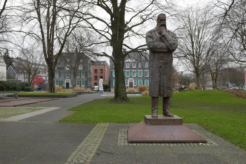 no people, building, bare tree, park, city, statue, built structure, branch, trunk, barmen, architecture, plant, tree trunk, tree, outdoors, friedrich engels