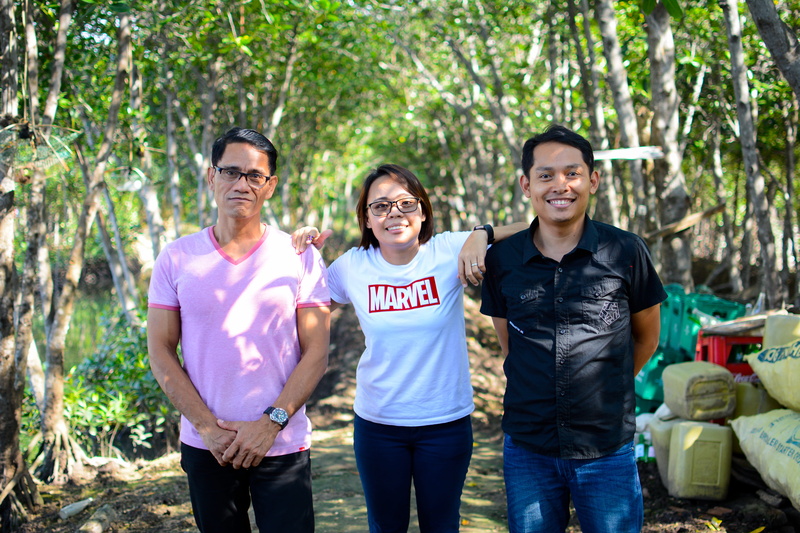 trees, community outreach, outdoors, men, portrait, group of people, casual clothing, teamwork, young men, looking at camera, three quarter length, happiness