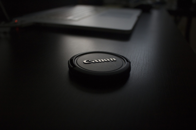 black color, photographic equipment, fun, camera lens, photos, no people, modern, shot, western script, communication, single object, control, focus on foreground