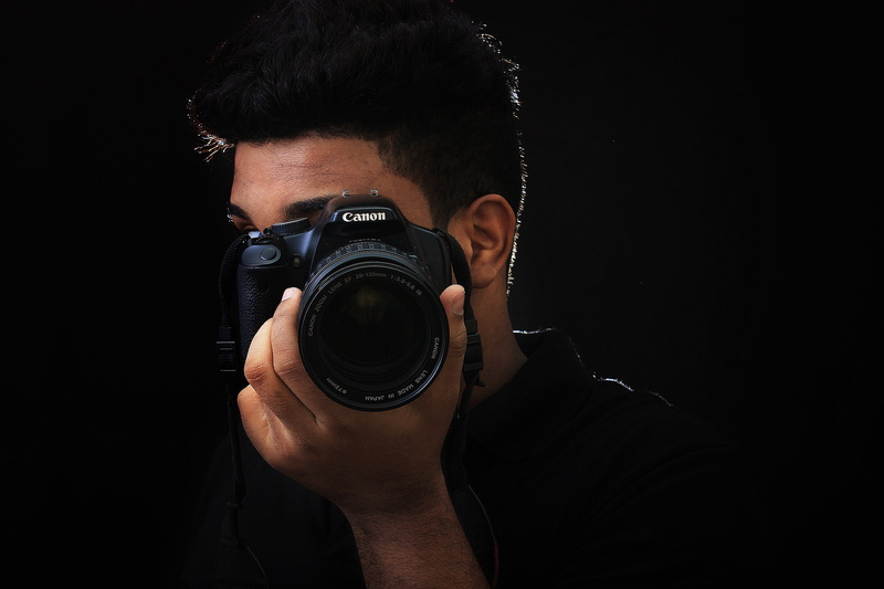 headshot, photographic Equipment, photographers, caucasian Ethnicity, activity, photo shoot, notebook, black background, photography, people, Canon, hobbies