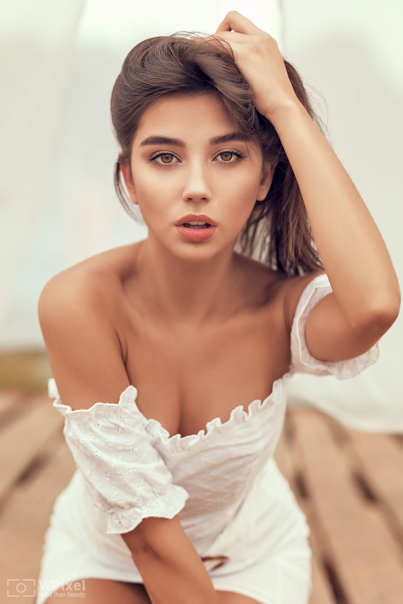 looking at viewer, dress, portrait display, model, 1080P, brown eyes, face, women, bare shoulders, bokeh, hand on head, brunette, depth of field