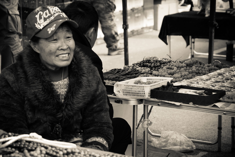 one Person, looking at camera, leisure activity, products, swap meet, adults only, front view, mid adult, mature men, one woman only, street, cultures