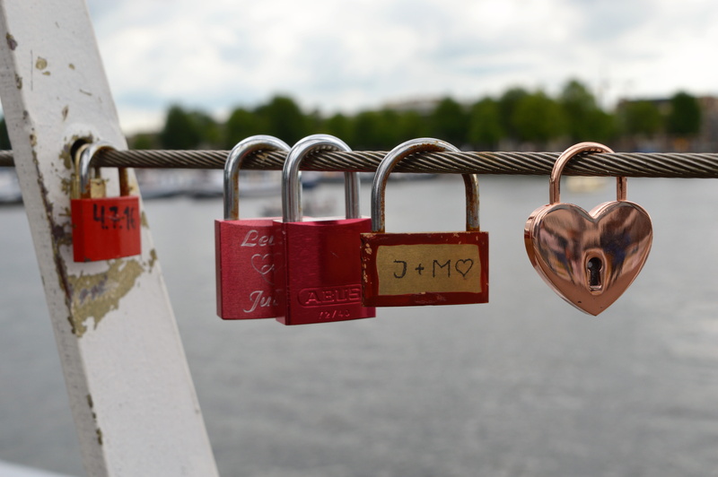 close-up, no people, hanging, protection, bridge, emotion, love lock, railing, text, hope - concept, day, heart, security and surveillance, message, red