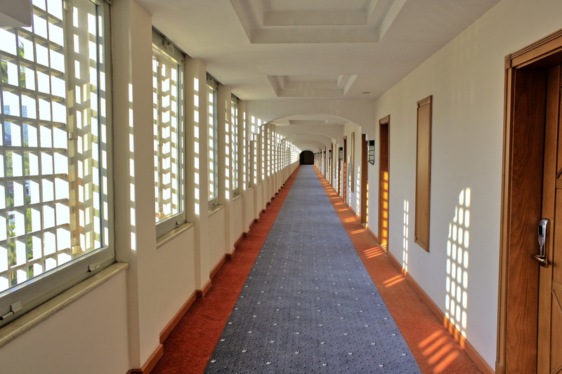 indoor, built structure, hotel, window, no people, direction, floor, ceiling, architectural column, interior, design, arcade, in a row, decor, indoors