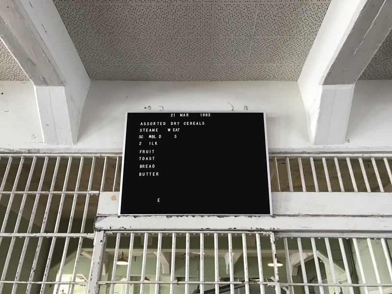 day, metal, indoors, sign, building, wall - building feature, low angle view, bar, dining hall, architecture, ceiling, architectural feature, cage, monitor