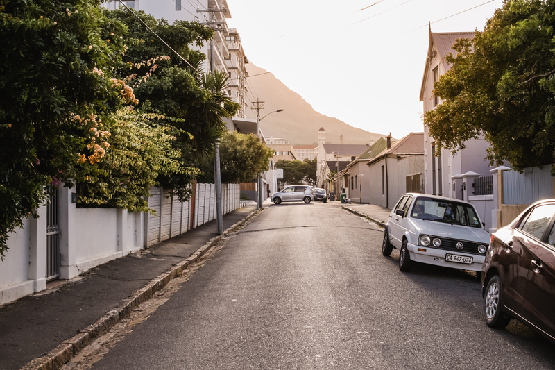 built structure, road, near, building, vehicle, car, town, tree, motor vehicle, light, two, the way forward, building exterior, parked, cars, no people