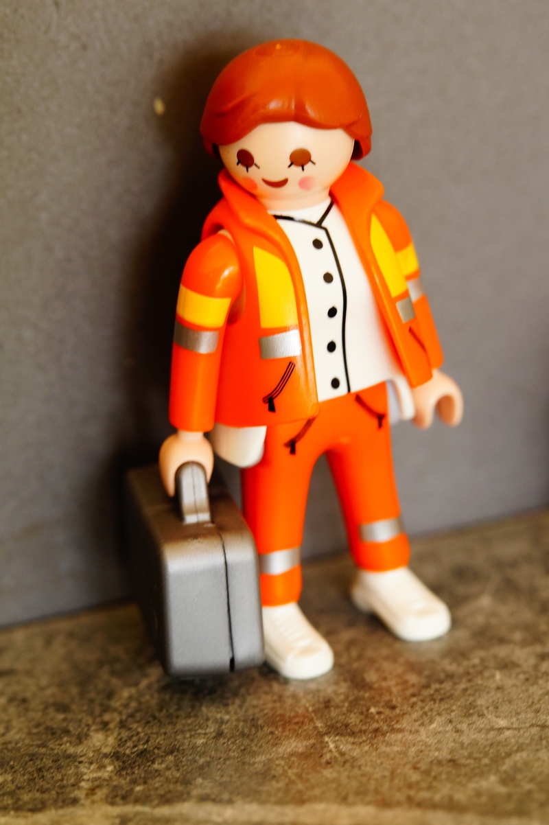 male likeness, human representation, disease, hospital, work clothes, doctor on call, people, still life, focus on foreground, indoors, table, orange color