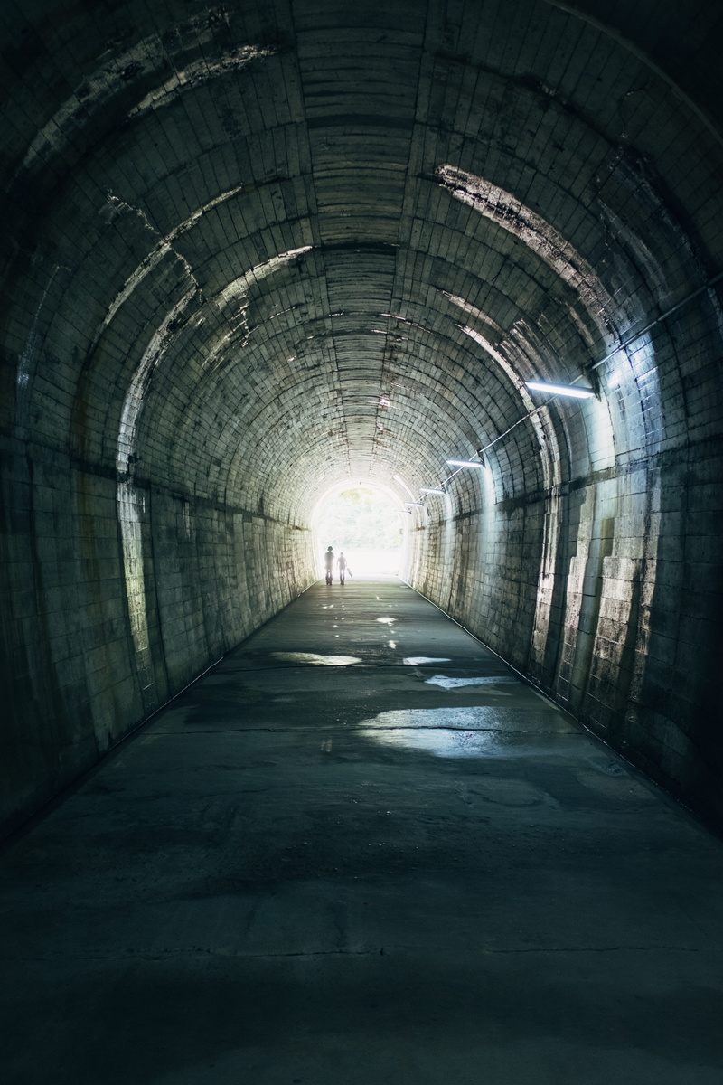 men, concrete, empty, 4K, real people, nature, full length, light at the end of the tunnel, arched, diminishing perspective, white, sunlight, direction