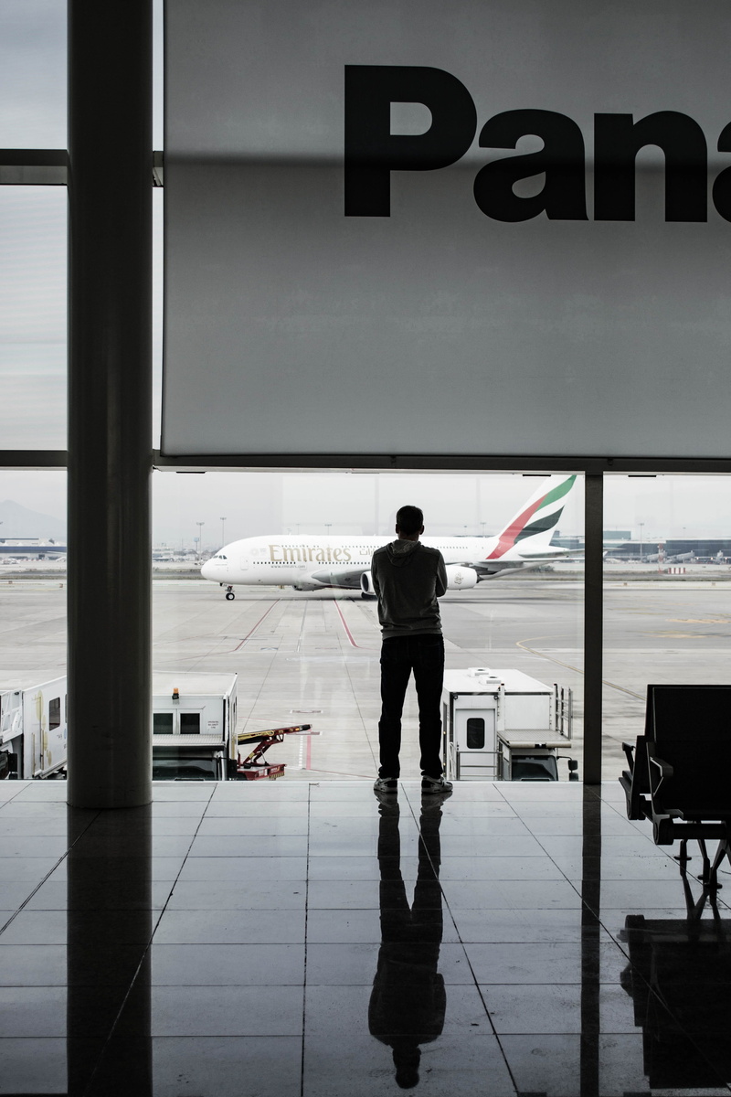 airport departure area, white, rear view, emirates, fly, lifestyles, port, facing, airplane, panasonic, airport terminal, mode of transportation, full length