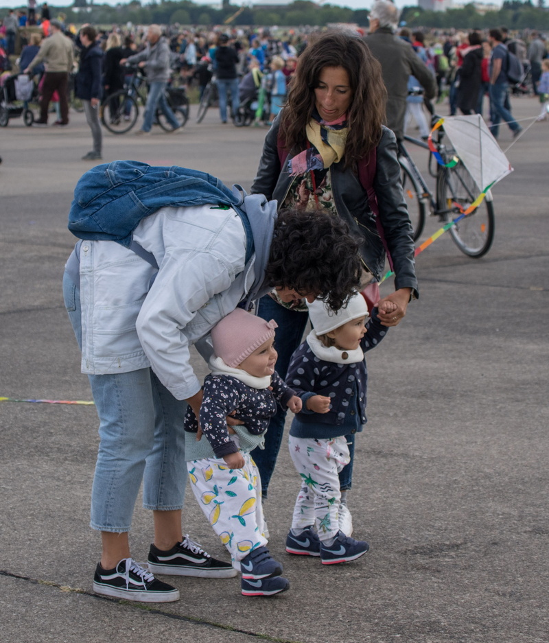 street, hairstyle, city, warm clothing, adult, child, twins, real people, pleasure, clothing, people, children, day, road, incidental people, human, women