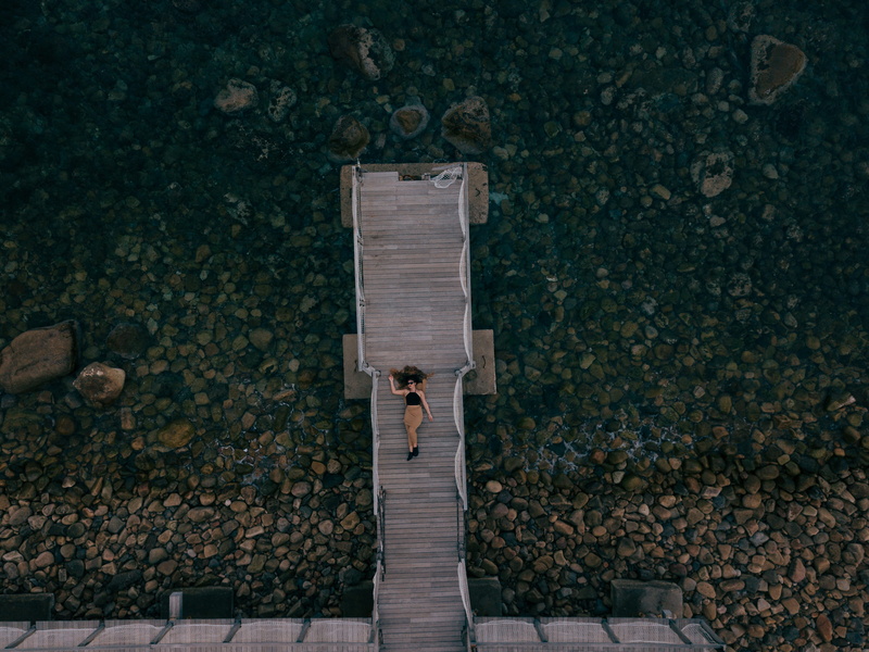 standing, wooden, day, body, looking down, view, top, one person, rock, boardwalk, adult, dock, lying, person, lying down, palermo, shore, drone, woman