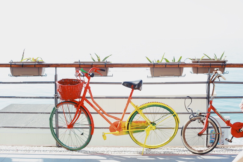 cycle, railing, street, transportation, italium, near, red, two, cycling, sunlight, colourful bike, golden hour, land Vehicle, yellow, bicycle, mode of Transport