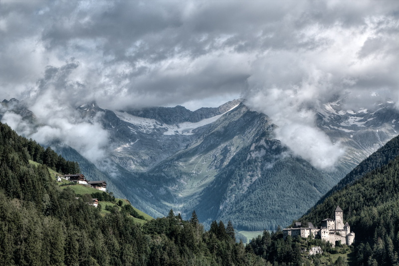 mountains, mountain, architecture, day, valley, tree, storm cloud, clouds, plant, environment, mountain range, outdoors, sky, forest, behind, storm, green