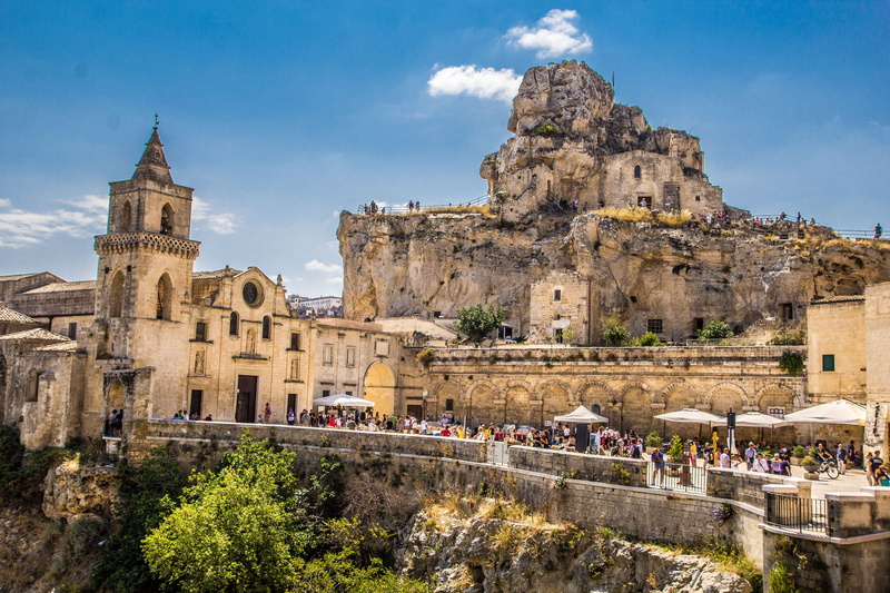 tourism, travel destinations, plant, san pietro caveoso, the past, large group of people, cliff, mountain, nature, travel, tree, ruined, cathedral, italy