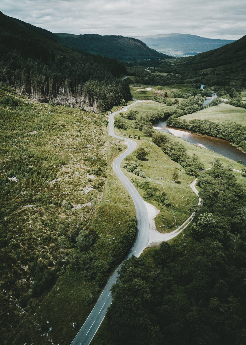 green color, winding road, outdoors, mountain road, view, highland, land, plant, non-urban scene, beauty in nature, river, woodland, tree, forest, landscape