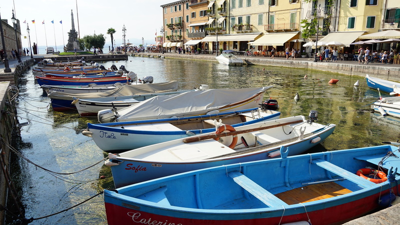 building exterior, lazise, anchored, no people, fishing boats, city, fishing industry, boats, rowboat, built structure, focus on foreground, day, port