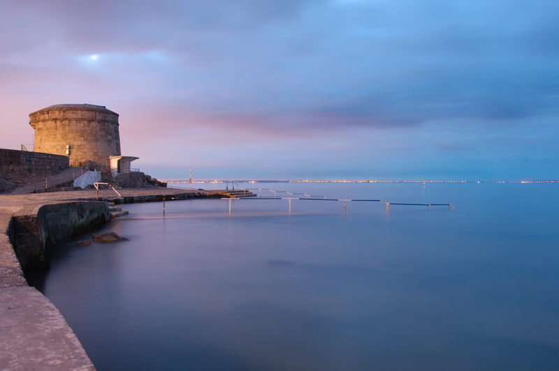 long exposure, tranquil scene, land, no people, waterfront, tranquility, outdoors, cityscape, sea, 2K, guard rails, rails, sky, water, building exterior
