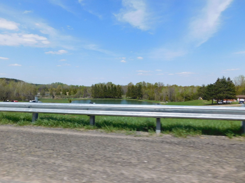 beauty in nature, cloud - sky, guard rail, sky, crash barrier, tree, lake, nature, tranquility, countryside, plant, water, blue, day, trees, no people