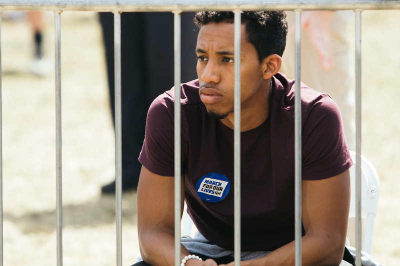 shirt, sports clothing, guard, wireless technology, maroon, adult, male, listening, technology, one person, sport, young men, men, lifestyles, railing