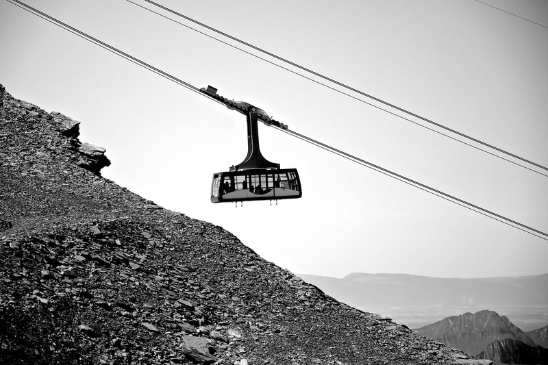 view, grey, low angle view, up, connection, sign, high, western script, hanging, lift, aerial passenger tramway, cliffs, black and white, transportation