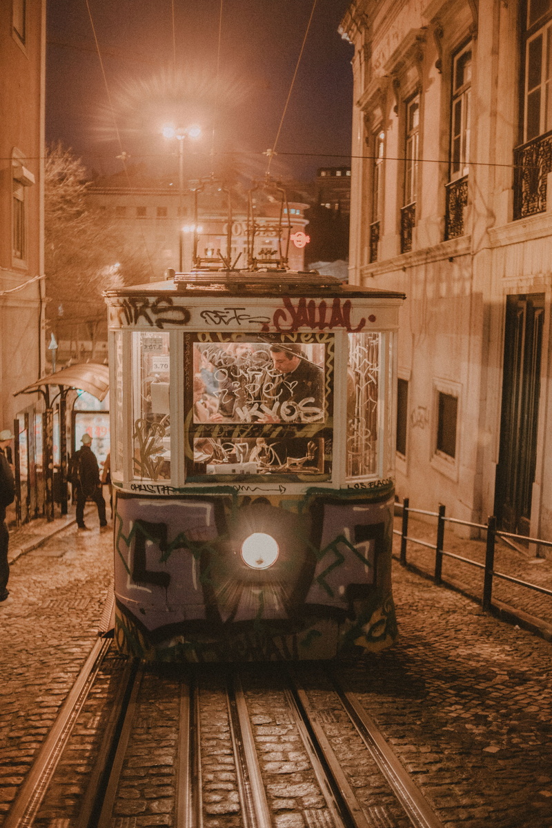 group of people, street light, portugal, cableway, street, night, illuminated, architecture, outdoors, train, urban, railroad track, building exterior