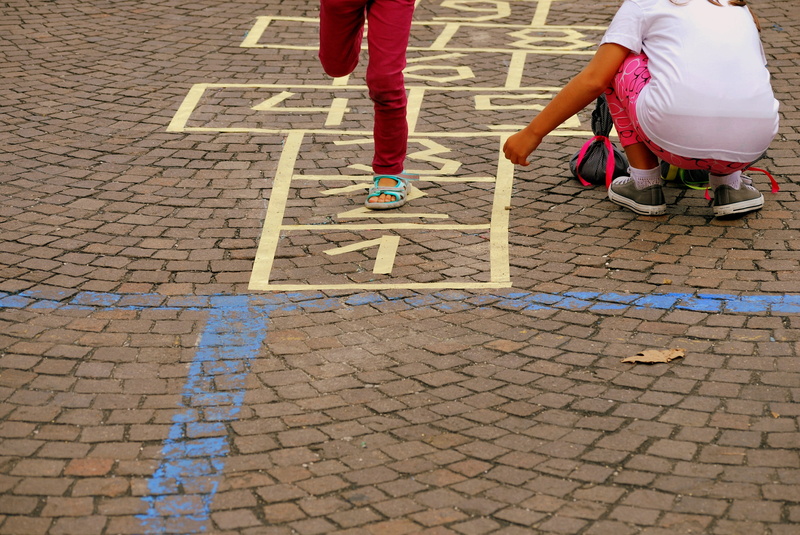 leisure activity, jump, city, low section, tocatì, road, street, people, two people, day, cobblestone, paving stone, outdoors, hopscotch, girls, women