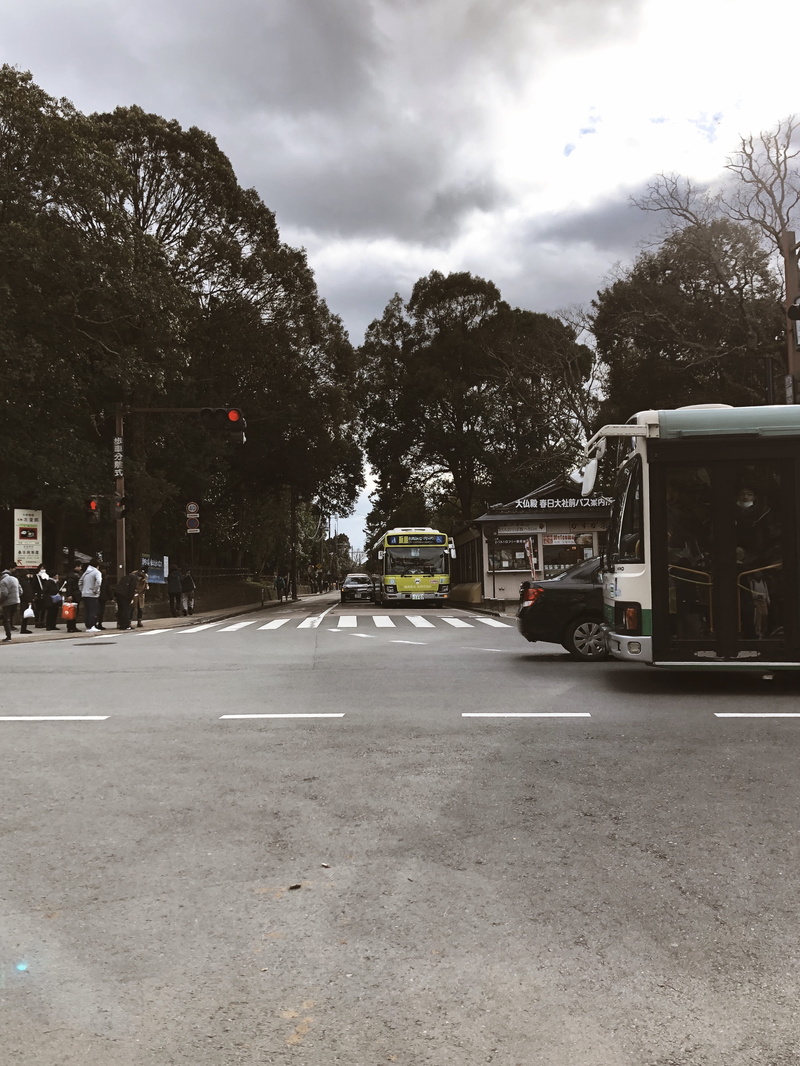 van, asphalt, sign, zebra crossing, intersection, way, cloud - sky, outdoors, land vehicle, human, mode of transportation, direction, bus, day, city, fire truck