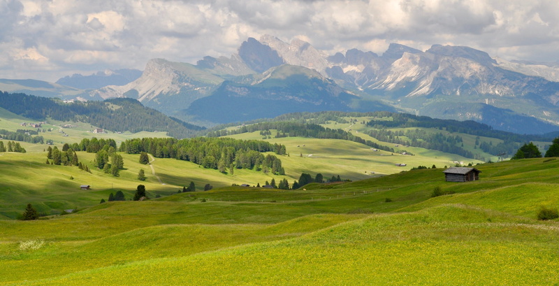 cloud - sky, field, mountain range, green, sky, grass, building, rolling landscape, valley, no people, panoramic, 2K, vibrant color, rural scene, mountain peak