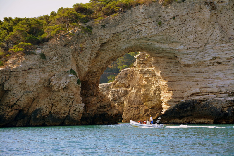 rock - object, lovers arch, tourists, waterfront, rock formation, natural arch, tranquility, boat, mode of transportation, tourism, gargano, scenics - nature