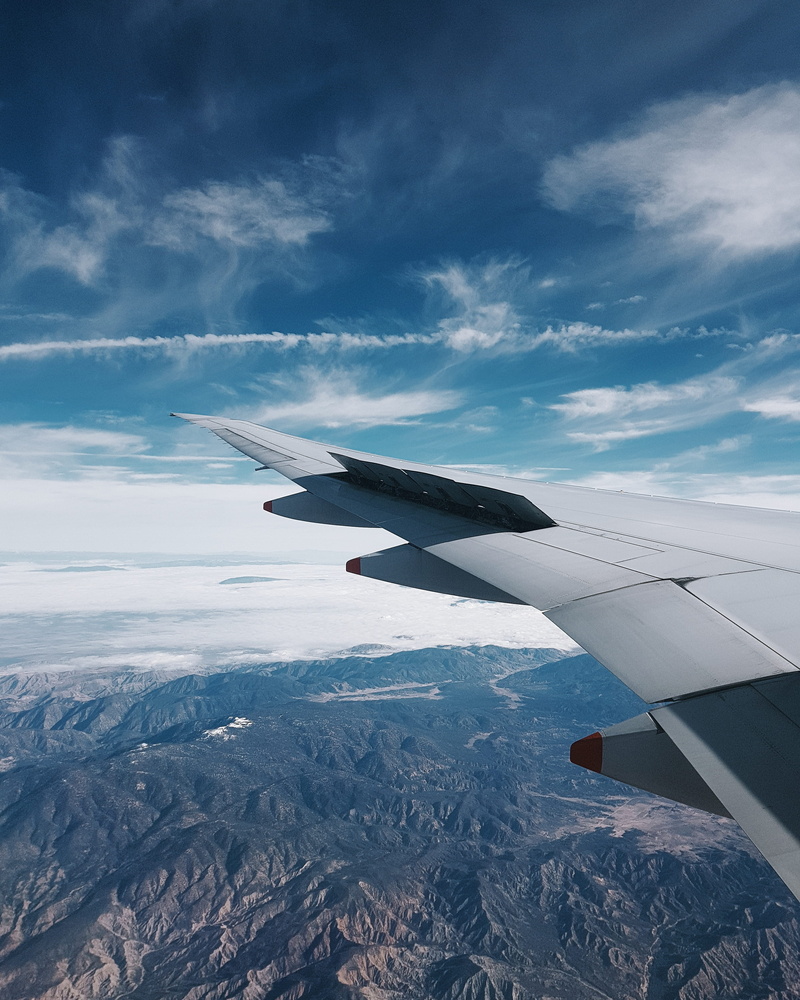 airplane, mode of transportation, 2K, sky, hills, mid-air, flight, grey, adventure, cloud - sky, environment, no people, window, nature, motion, day, scenics - nature