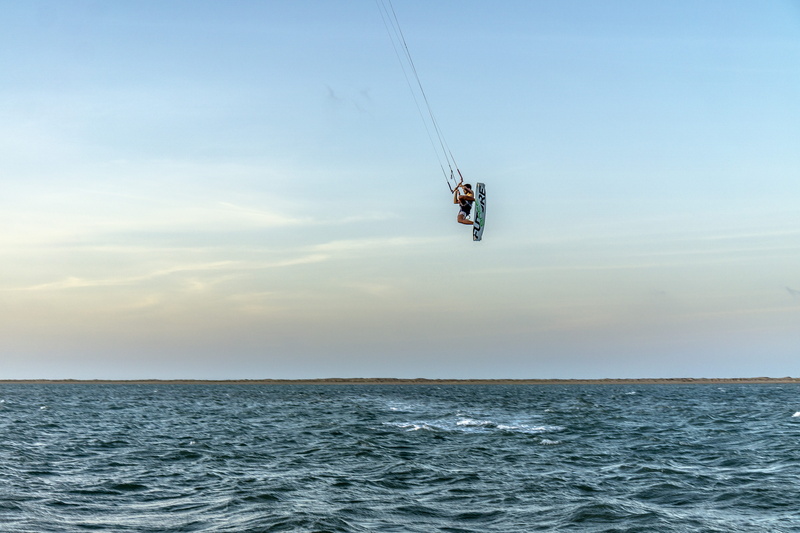 waterfront, day, lifestyles, water, nature, adventure, ocean, horizon, kitesurfing, sea, outdoors, beauty in nature, mid-air, unrecognizable person, kiteboarding