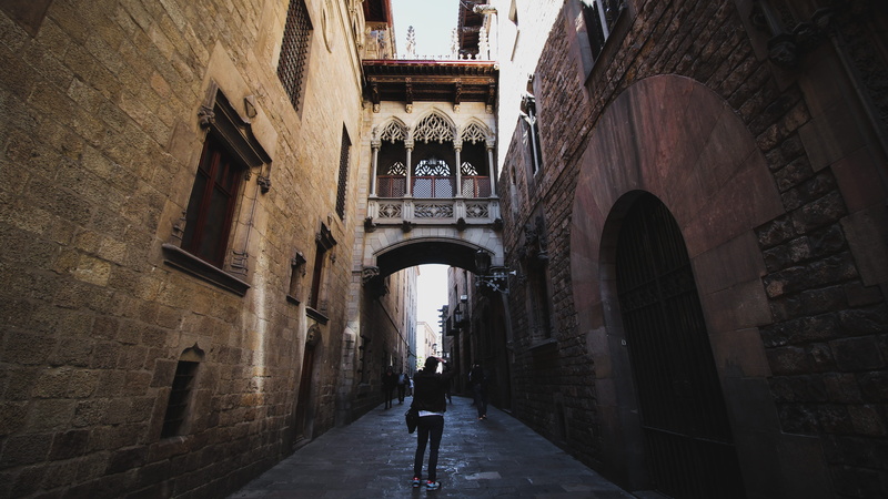 city, men, arch, outdoors, architecture, women, day, one person, spain, barcelona, rear view, leisure activity, full length, alley, built structure, the way forward